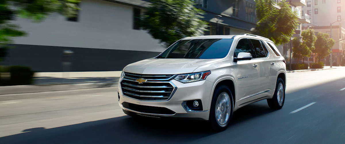 2019 Chevrolet Traverse driving down street during day