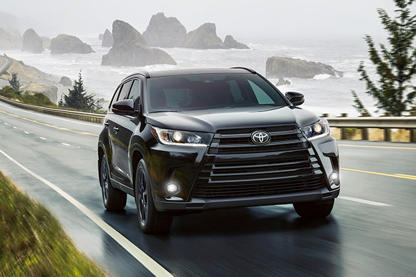 2019 Toyota Highlander driving on road by water in day