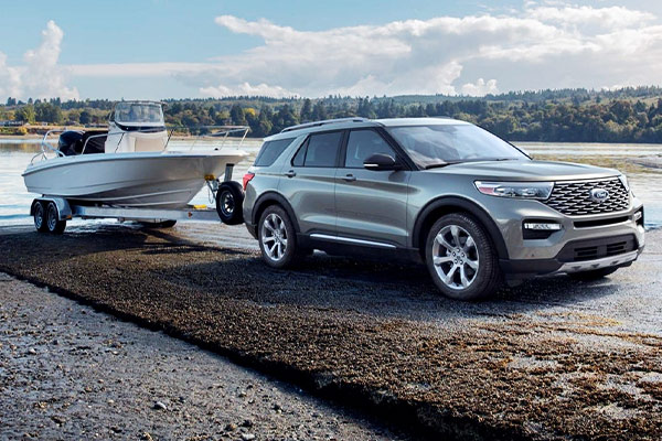 silver ford explorer pulling a boat on the road