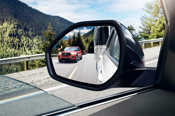 ford explorer side mirror showcasing blind spots assist