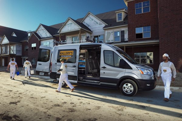 Service workers unloading work gear out of the 2020 Ford Transit Van