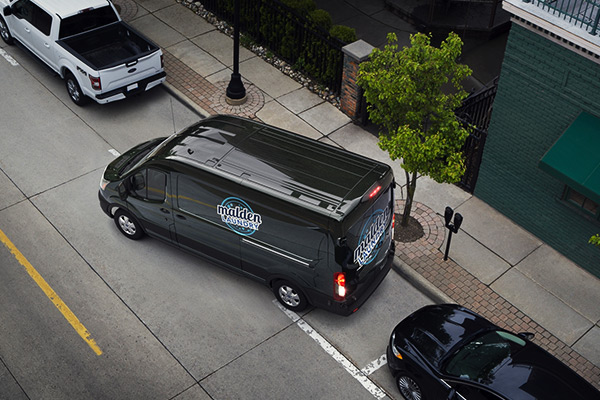 A 2020 Ford Transit being parallel parked