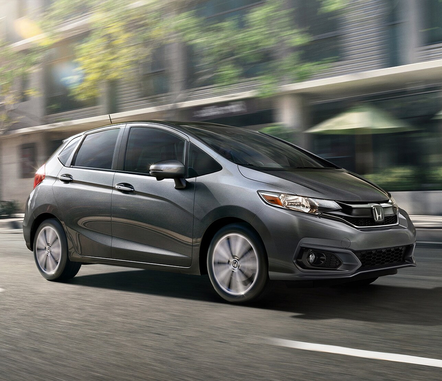 Front passenger-side view of the 2020 Honda Fit EX-L in Modern Steel Metallic driving on the road.
