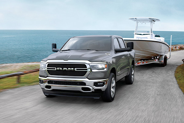 2020 RAM 1500 towing boat along the water