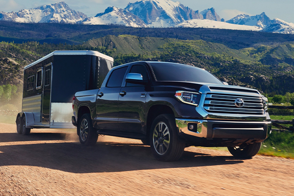 2020 Toyota Tundra towing trailer in dirt road