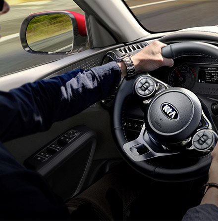 Inteior view of man holding steerign wheel while driving