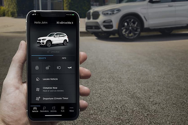 BMW owner holding their phone out to show their BMW Connected app