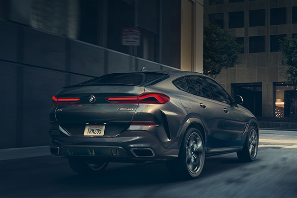 Rear shot of a 2021 BMW X6 in an alley at night