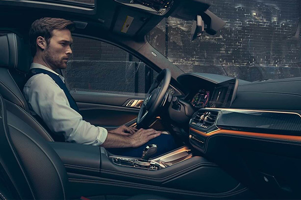 Interior shot of A person in the driver's seat of a 2021 BMW X6