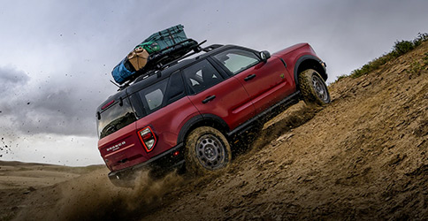 A 2021 Ford Bronco Sport being driven off road in the desert