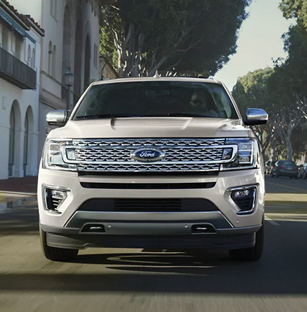 Front view of a 2021 Ford Expedition driving through town
