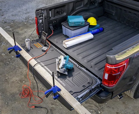 Tools in the bed and on the tailgate work surface of a 2021 Ford® F-150