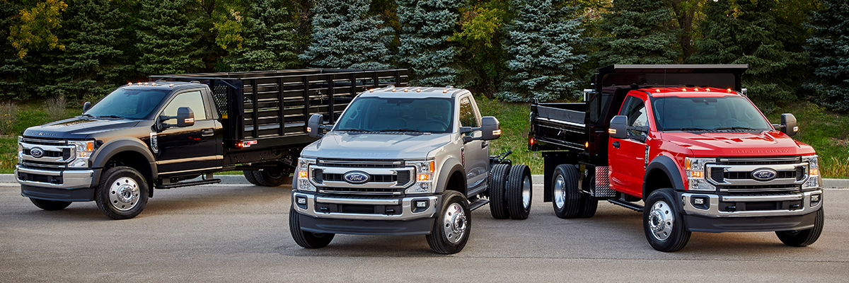 2021 Ford Super Duty® F-600 lineup with evergreen trees in the background