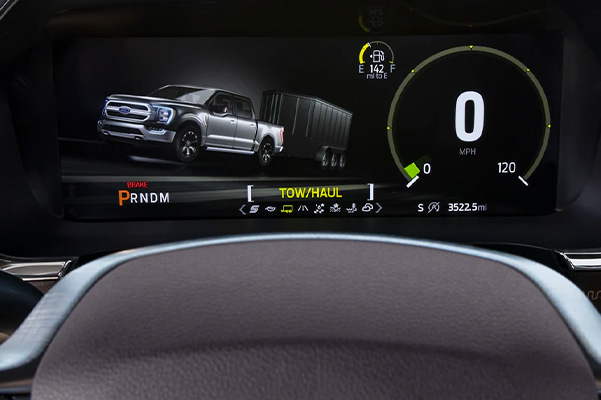 Steering wheel dash displaying tow/faul information with fuel gage