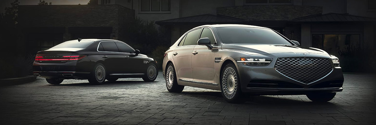 2021 Genesis G90 vehicles parked away from each other in a dark parking lot