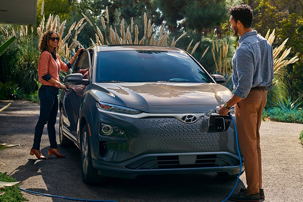 2021 Hyundai Kona EV charging in driveway