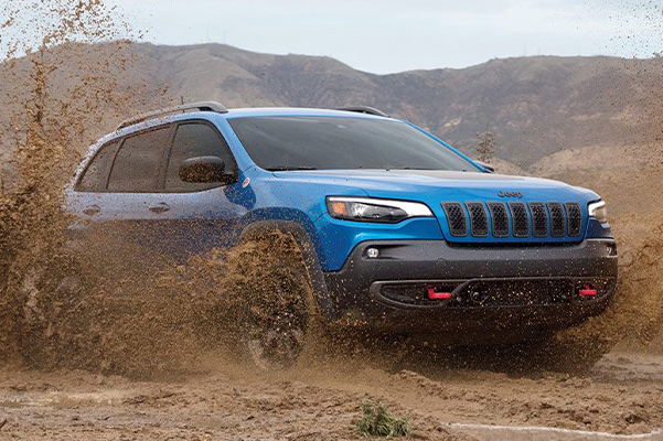 Jeep Cherokee driving through mud