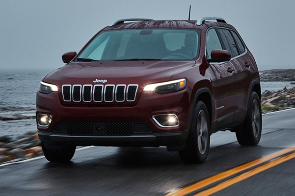 Jeep Cherokee driving on wet road
