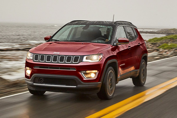Jeep Compass driving on wet road