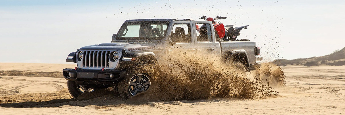 2021 Jeep Gladiator driving through sand