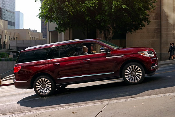 2021 Lincoln Navigator driving uphill on a city street