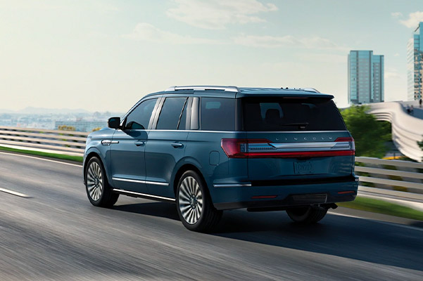 Rear shot of the 2021 Lincoln Navigator driving over a bridge