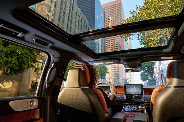 Interior shot of the 2021 Lincoln Navigator to show the panoramic vista roof and touch screen navigation