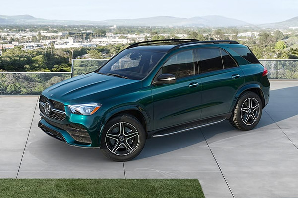 2021 Mercedes-Benz GLE 350 in Emerald Green parked on a driveway overlooking a city