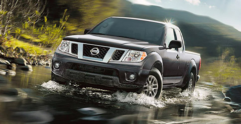 2021 Nissan Frontier driving through the water