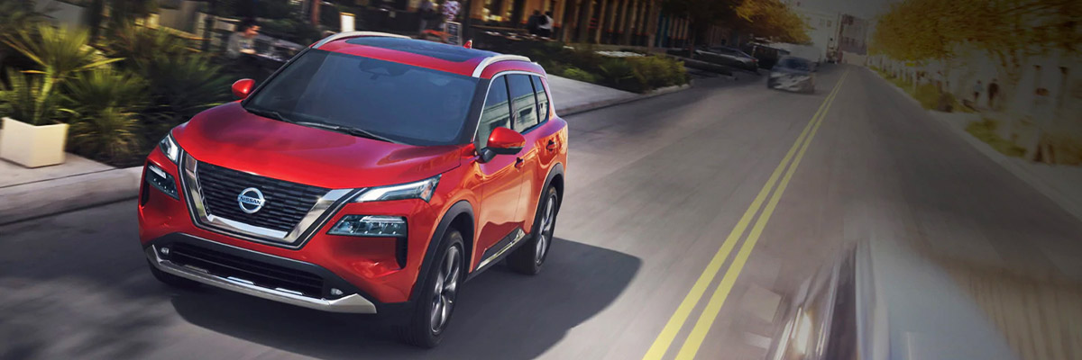 2021 Nissan Rogue driving down city street