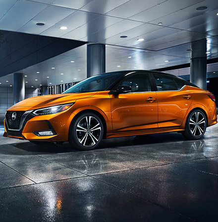 Side profile of the 2021 Nissan Sentra parked under a well lit garage