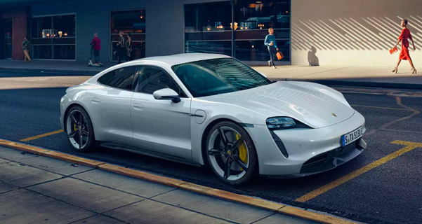 2021 Porsche Taycan parallel parked on a busy street