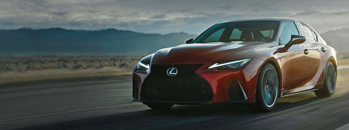 2022 Lexus IS 500 driving down a scenic highway