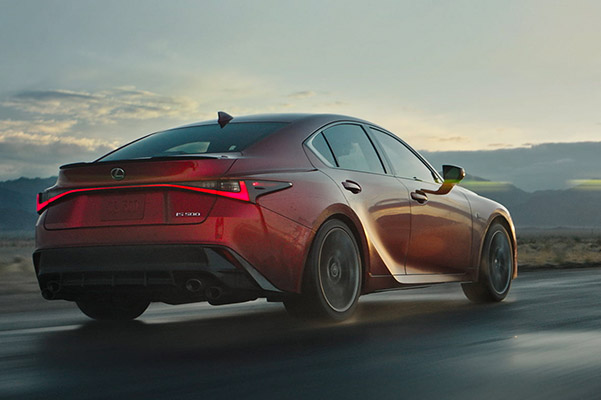 Rear shot of the 2022 Lexus IS 500 driving down a scenic highway