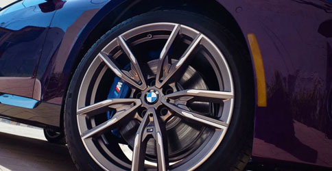 Detail of wheel design and blue caliper M Sport Brakes on a new 2022 BMW M240i xDrive Coupe