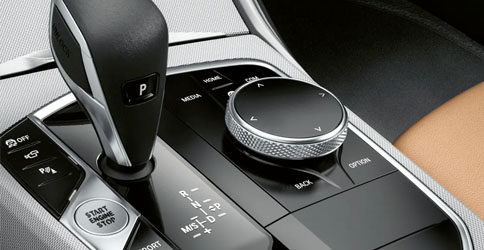 Detail of the gear shifter and drive mode controls in a 2022 BMW 2 Series Coupe