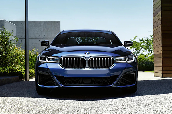 Front exterior shot of a 2022 BMW 5 Series parked in a driveway