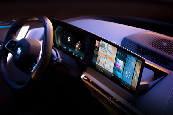 The 2022 BMW iX interior drivers side and dashboard lit up at night