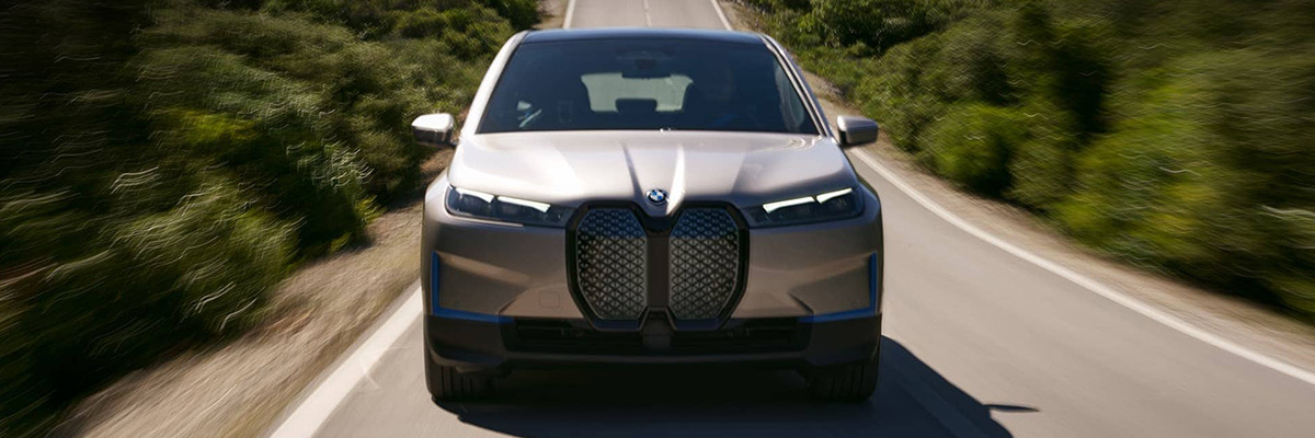 2022 BMW iX front view driving down the road