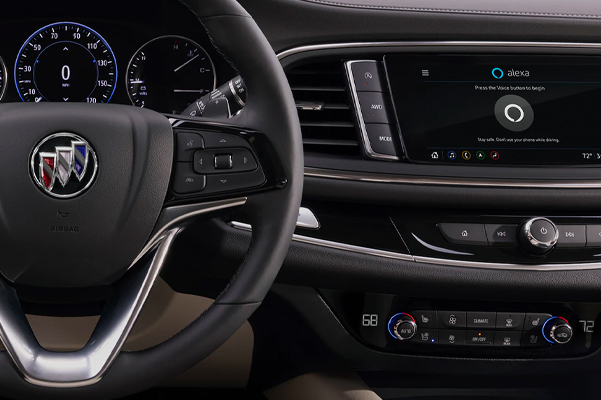 Interior detail shot of the steering wheel and dashboard in a 2022 Buick Enclave.