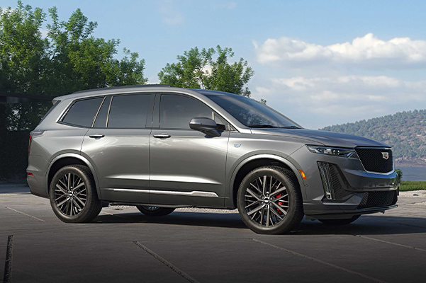 side shot of a 2022 Cadillac XT6 with trees in the background