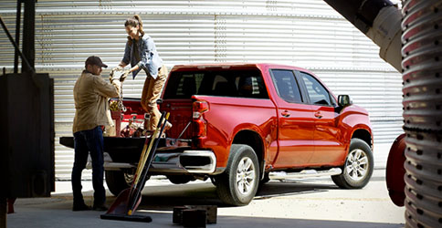 Workers Loading Up Durabed of 2022 Chevy Silverado LTD