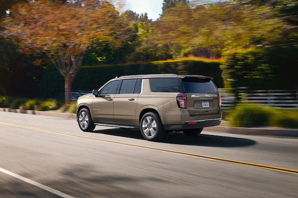 2022 Chevrolet Suburban Full-Size SUV Exterior Rear Side View Driving