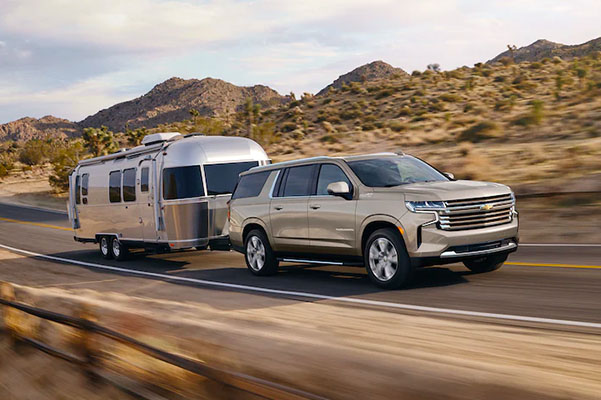 2022 Chevrolet Suburban Full-Size SUV Exterior Front Side View Pulling Trailor