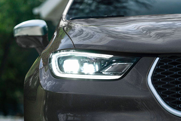A close-up of the headlamp on the 2022 Chrysler Pacifica Pinnacle.