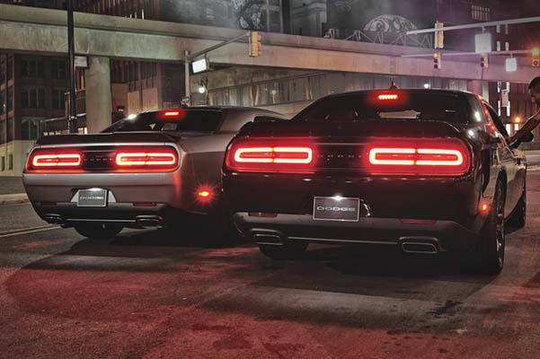 Rear view of two Challengers, R/T Scat Pack to the left and R/T Scat Pack to the right shown.