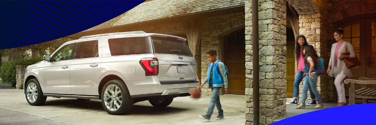 Family walking by Ford Expedition