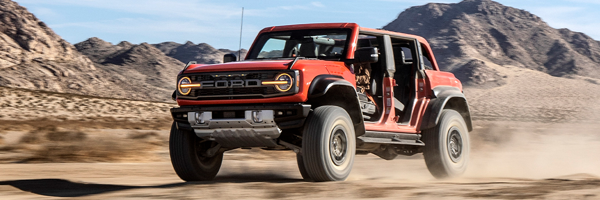 2022 Ford Bronco Raptor™ driving fast in desert-like terrain