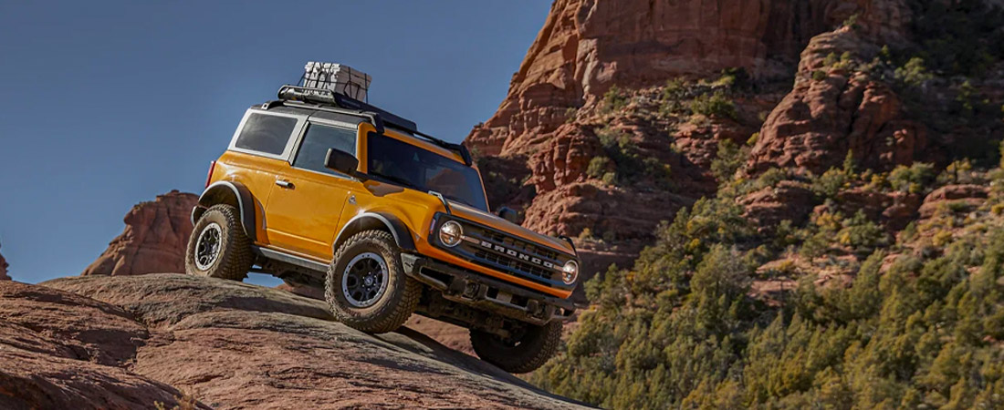 The 2022 Ford Bronco driving down a boulder in the mountains