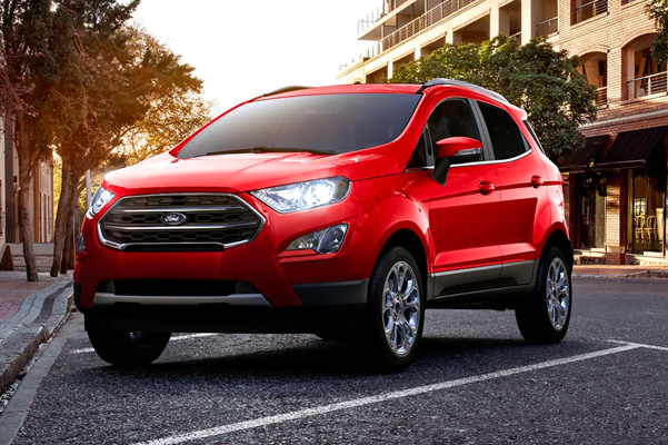 Red 2022 Ford EcoSport parked in street parking during the sunset
